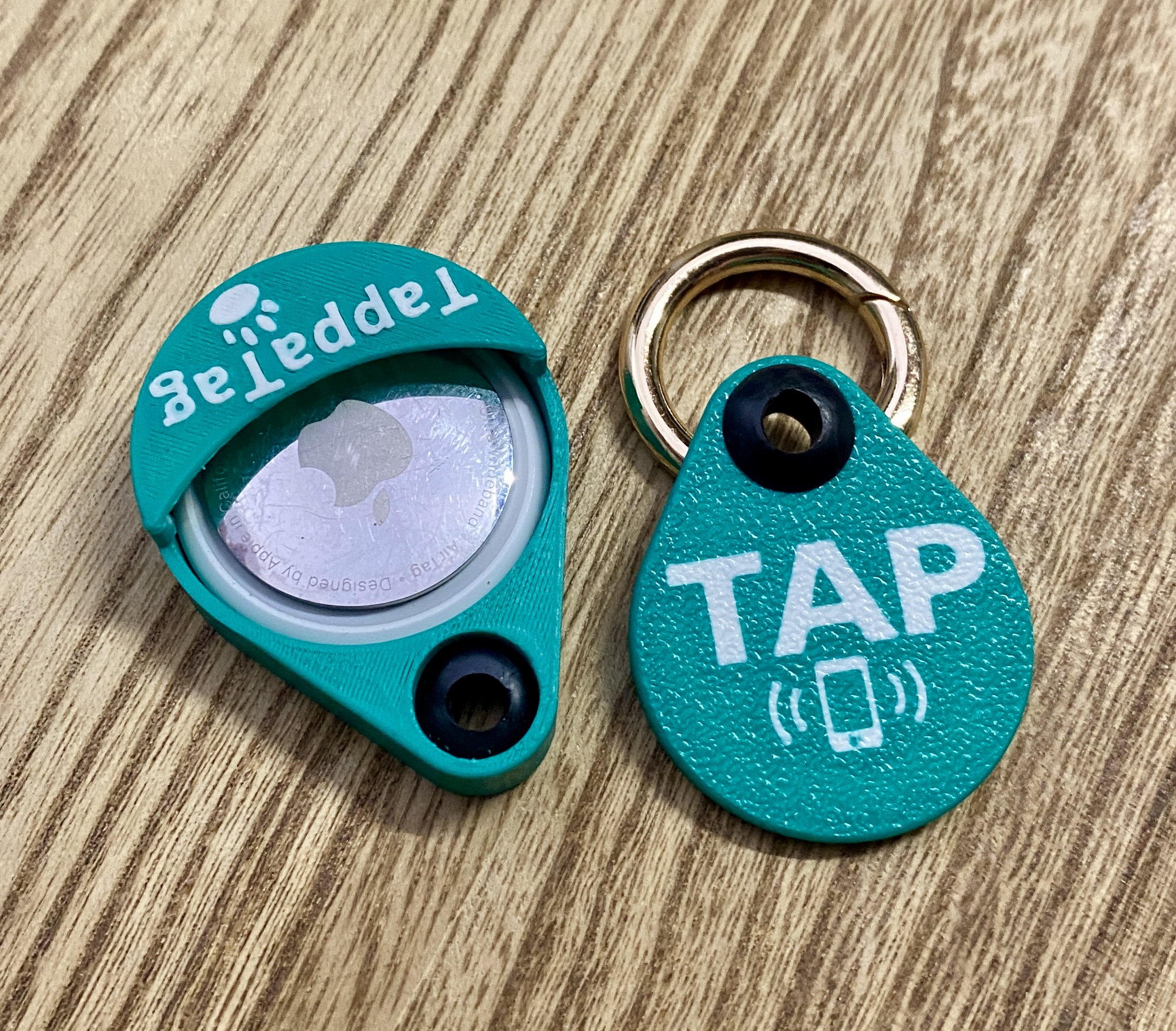 TappaTag housing open, showing AirTag slotted inside next to the NFC tap tag